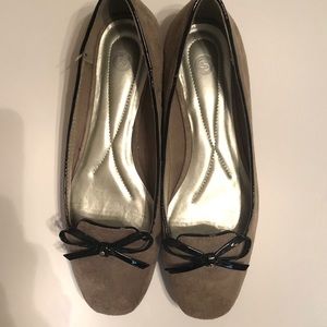 Tan suede flats with black trim